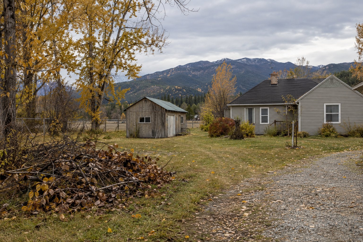 Rural property with contained branches awaiting cleanup in fall